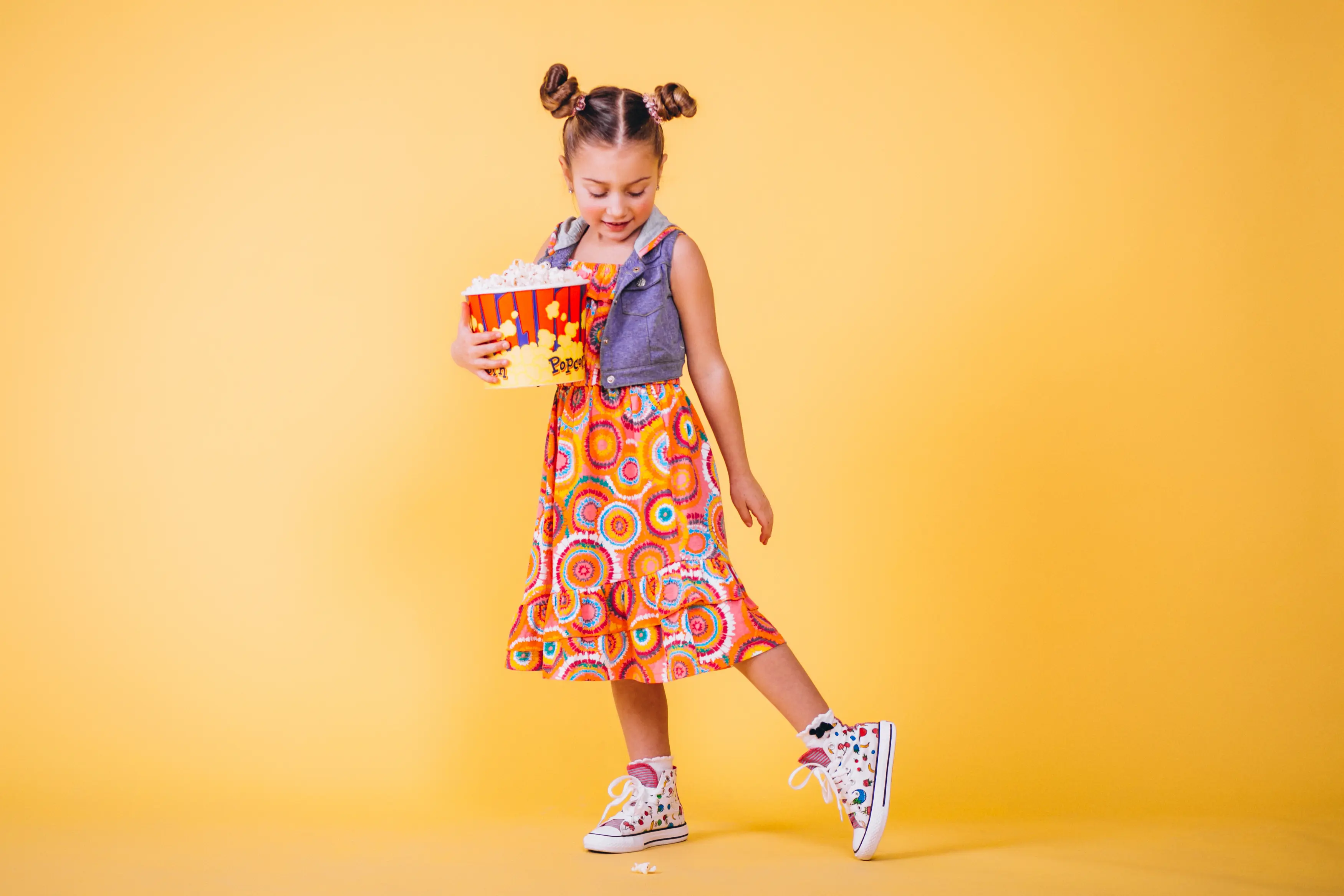 Girl in colorful dress with popcorn